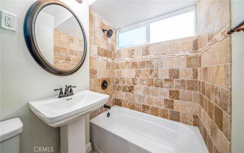 Hallway bathroom. Travertine Tile in all the bathrooms.