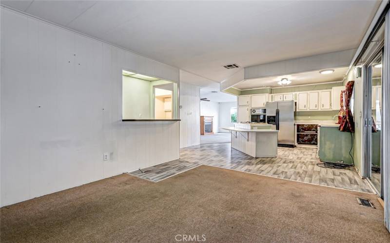 view from the large family room towards the kitchen (sliding door on the right goes out to enclosed porch rooms added later)