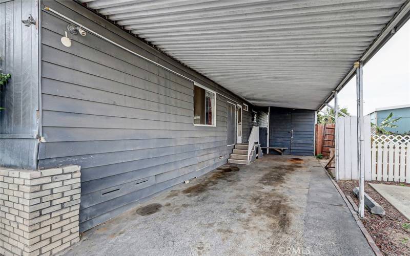 carport with large storage shed at the end