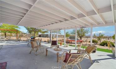 Covered patio, cowboy tub, and views of the horse property