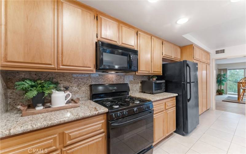 You see plenty of counter space cabinet space and tile flooring.