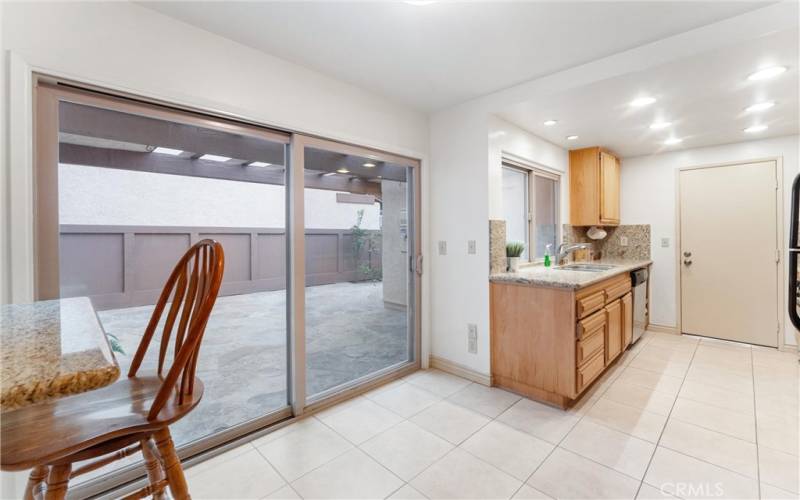 As you enter the large kitchen area you are greeted by the breakfast counter, sliding door that leads to the large front yard, granite kitchen counter tops.