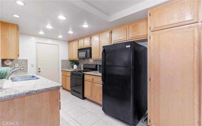 From this angle you see more of the spacious kitchen with plenty of cabinet space including pantry.