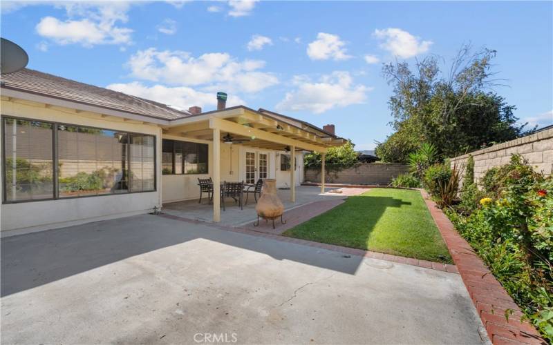 Backyard with covered patio.