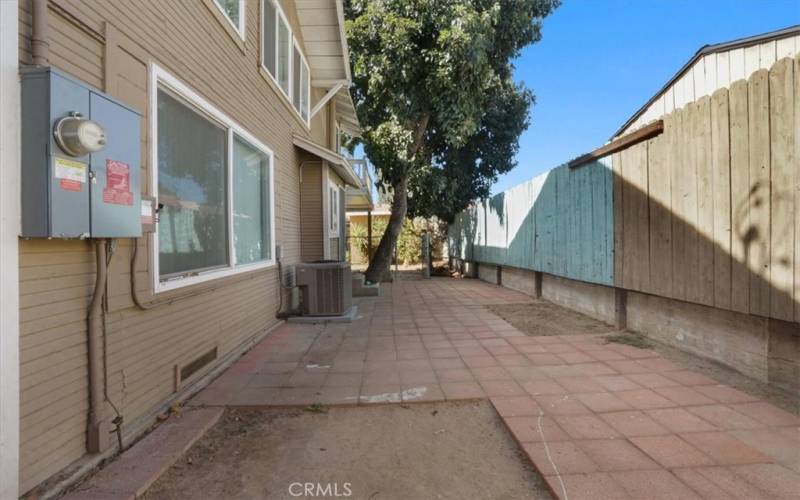 The side yard has pavers and an electrical and solar panel installed in 2022.