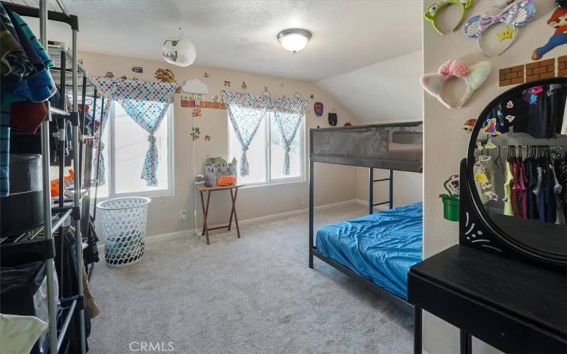 Bedroom 3 is next to the primary bedroom and has large windows to let the natural light flow throughout.