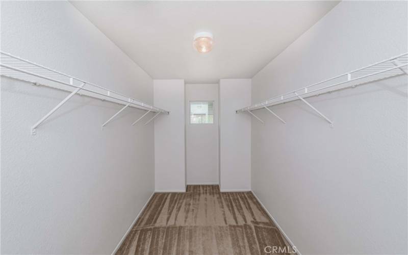 Primary bedroom walk-in closet