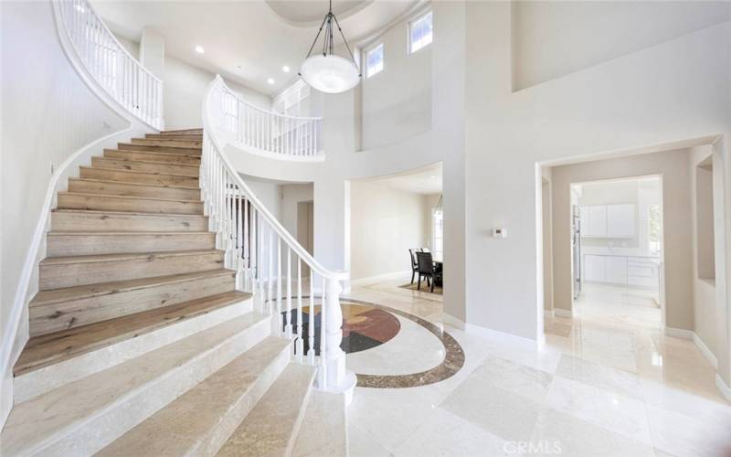 Polished Travertine Floors with Sweeping Staircase