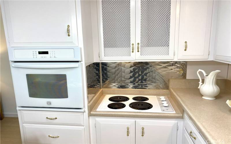 Newer oven and cooktop are white.