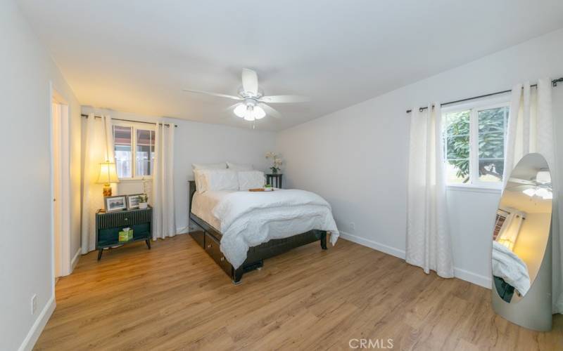 Primary bedroom with dual windows and closets plus an en-suite.