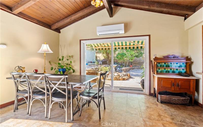 You enter into the dining area through a large, newer sliding glass door.  Notice the mini-split which is used for heating and cooling.