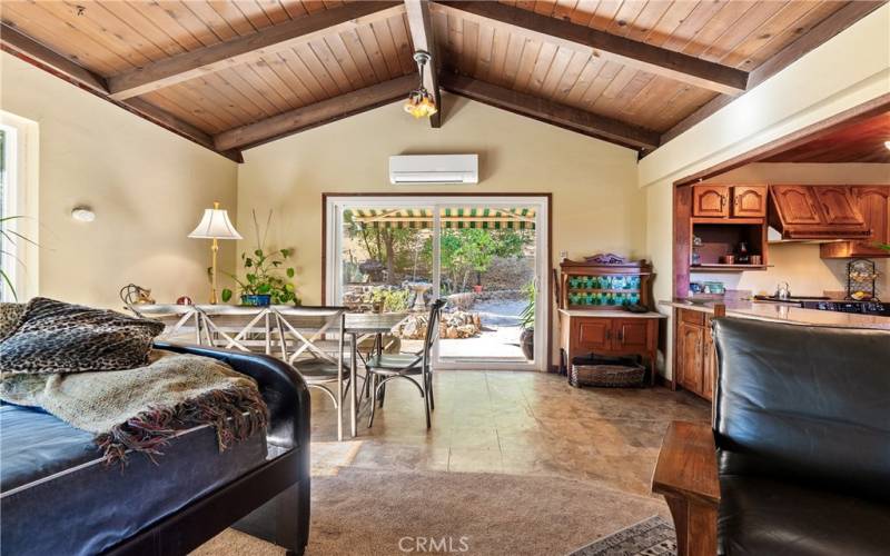 The dining area is enriched with vaulted wood beam ceilings and incredible natural light.