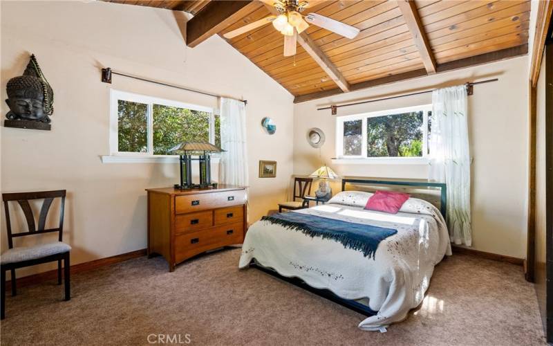 Bedroom 3 is located off the living room and offers vaulted wood ceilings and a large closet.