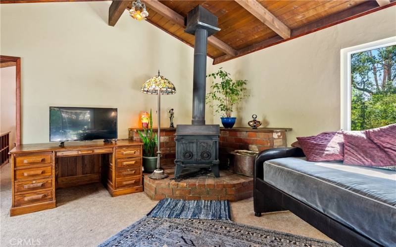 Keep warm on cool evenings with the wood burning stove set atop a pleasing red brick hearth!