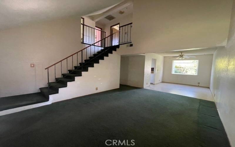 Living room into dining room shows stairway