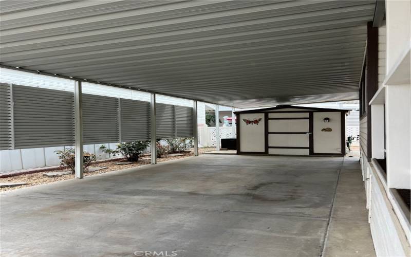 Covered patio cover provides shade for the patio and cars.