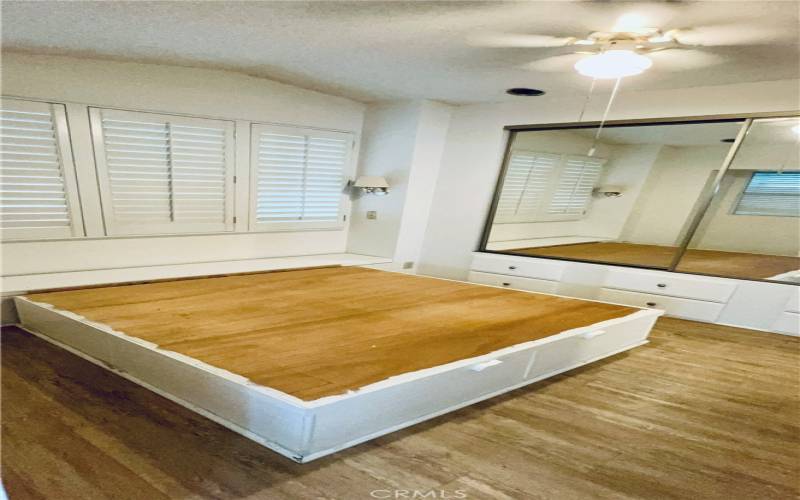 Bedroom with extra storage if you lift the top of that bed frame.