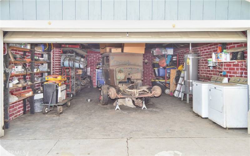 The smaller of the 2 garages which offers 532 sq ft of space with faux brick paint and laundry hook-ups.