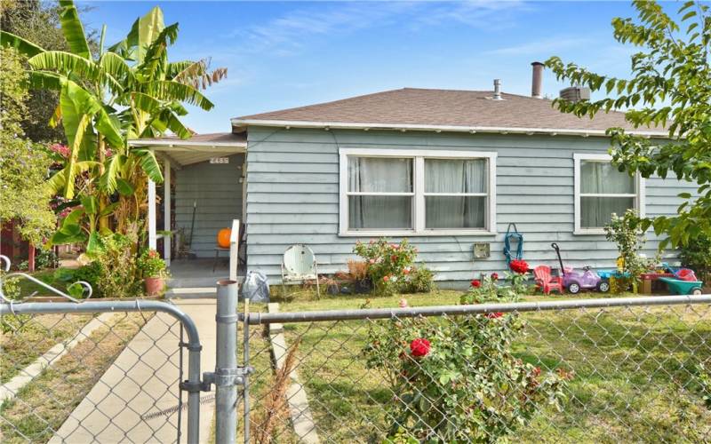 This charming home sits on a corner lot with a fenced and cross-fenced yard full of possibilities. The front yard has walkways from both gates, a grassy lawn, shade trees, roses, and more greenery to create an inviting space to play.