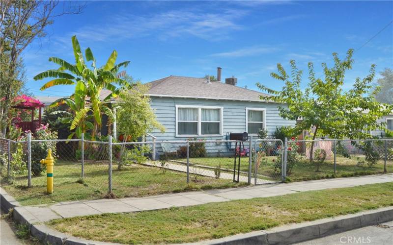 This charming home sits on a corner lot with a fenced and cross-fenced yard full of possibilities. The front yard has walkways from both gates, a grassy lawn, shade trees, roses, and more greenery to create an inviting space to play.