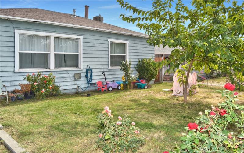 This charming home sits on a corner lot with a fenced and cross-fenced yard full of possibilities. The front yard has walkways from both gates, a grassy lawn, shade trees, roses, and more greenery to create an inviting space to play.