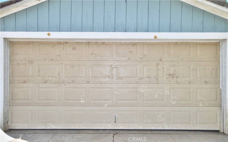 The smaller of the 2 garages which offers 532 sq ft of space with faux brick paint and laundry hook-ups.