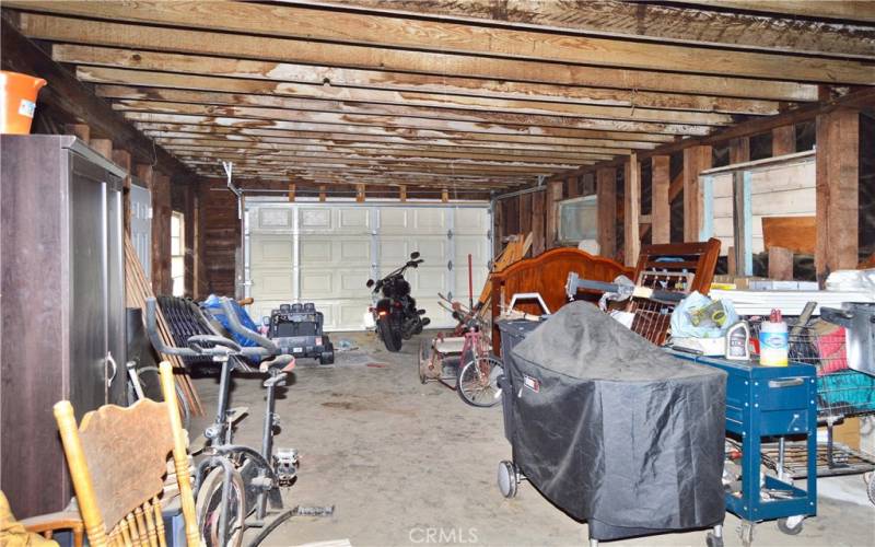 Interior view of the larger (2nd) garage which offers 846 sq ft of space for cars, toys, hobbies, storage, or maybe even an ADU. There are so many possibilities to explore here!