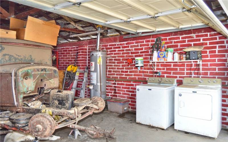 The smaller of the 2 garages which offers 532 sq ft of space with faux brick paint and laundry hook-ups.