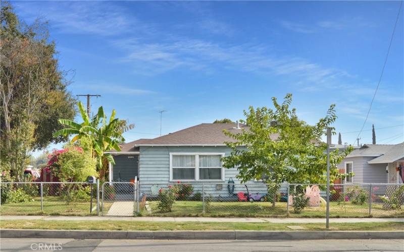 This charming home sits on a corner lot with a fenced and cross-fenced yard full of possibilities. The front yard has walkways from both gates, a grassy lawn, shade trees, roses, and more greenery to create an inviting space to play.