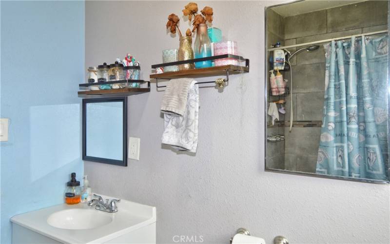 The main bath was remodeled in 2018 with new porcelain tile flooring, tiled shower walls with mosaic accents, new tub, new shower faucet, new vanity, and a new toilet.