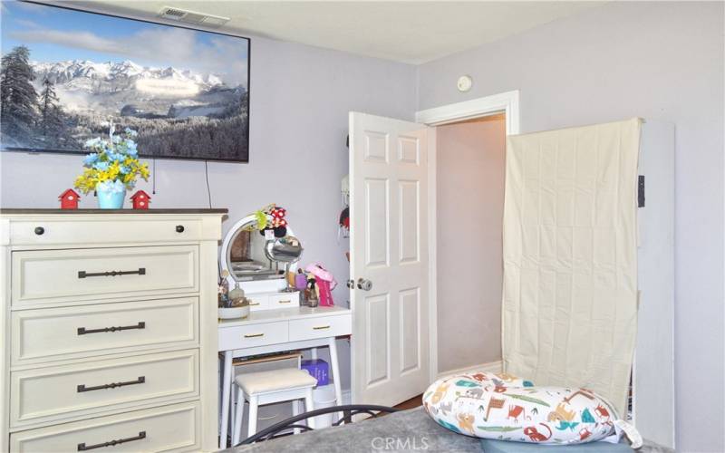 The primary bedroom looks out on the front yard and features more of that gorgeous wood laminate flooring and a modern ceiling fan light.