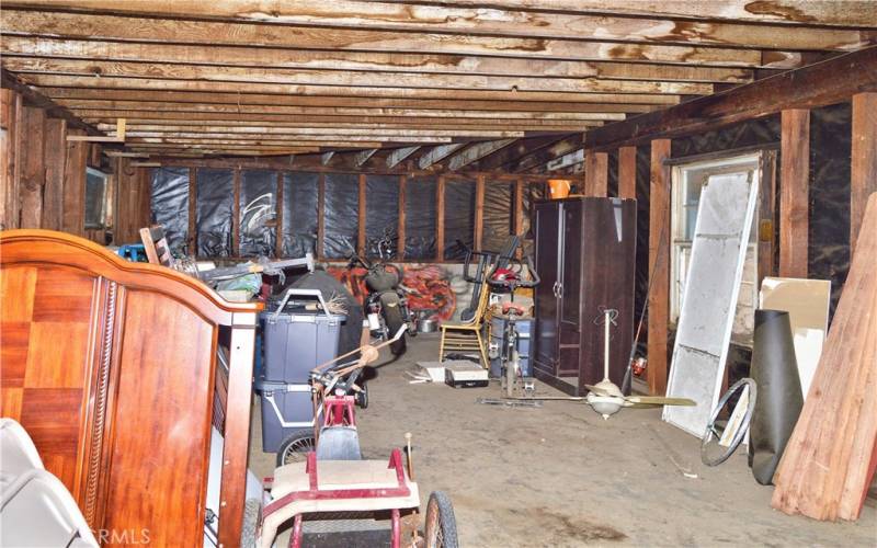 Interior view of the larger (2nd) garage which offers 846 sq ft of space for cars, toys, hobbies, storage, or maybe even an ADU. There are so many possibilities to explore here!