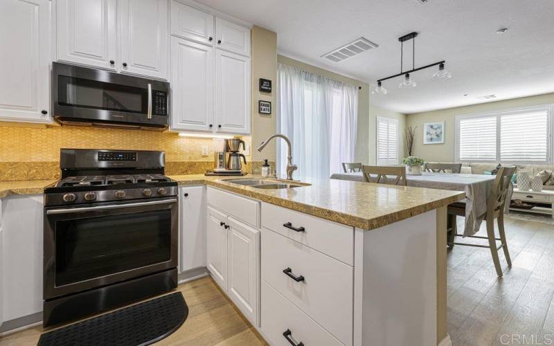 Custom built Kitchen Cabinetry with Real wood, backsplash, ample storage space and Recessed lighting