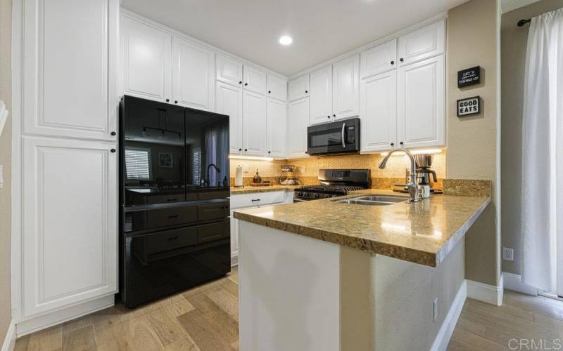 Custom Built Cabinetry with Real Wood! Reeces lighting, Ample storage, Stainless steel appliances.