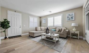 Enter to a large open space filled with Natural Lighting, Real wood floors and plantation shutters.