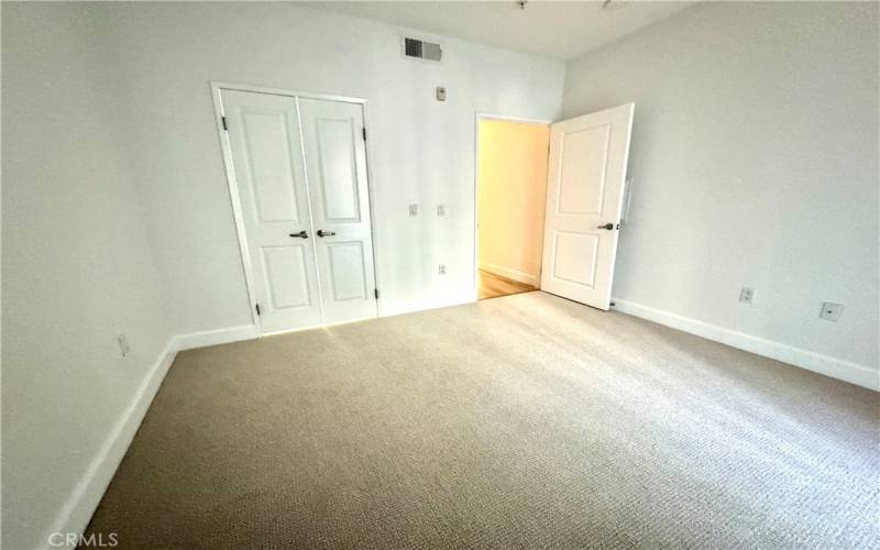 View of bedroom looking towards closet and door