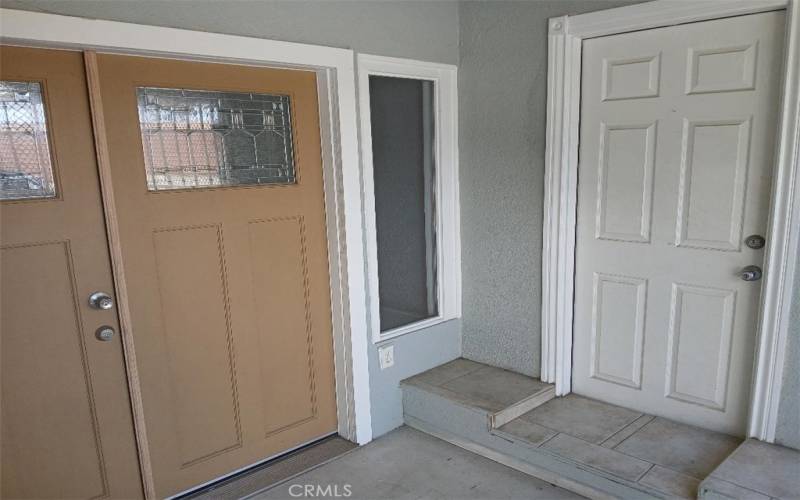 Side white door is entrance to tenant unit with bath and kitchenett.