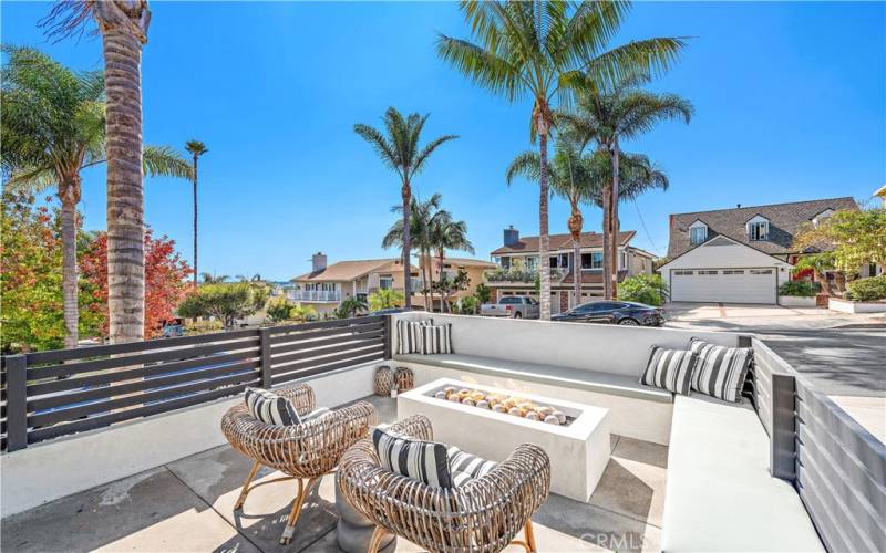 Front yard has an additional fire pit, seating and peek a boo ocean views.