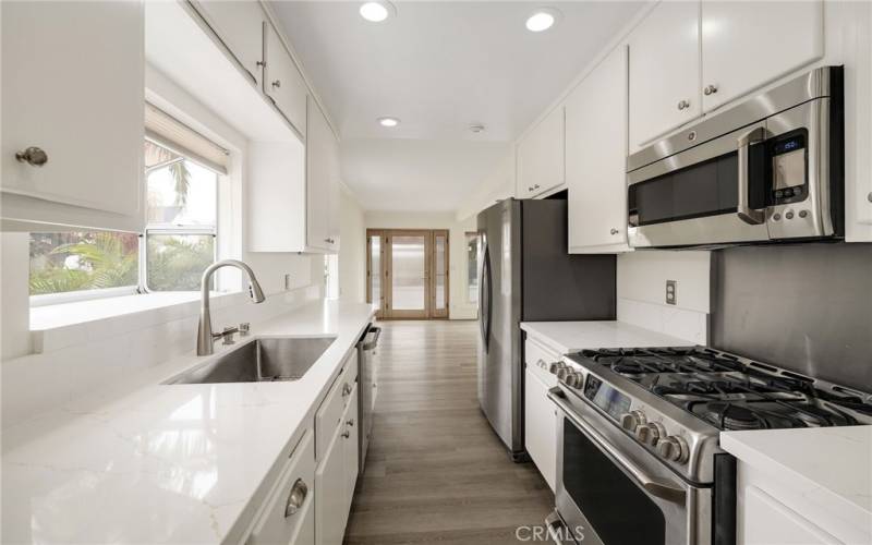 galley kitchen with newer appliances and new marble counters