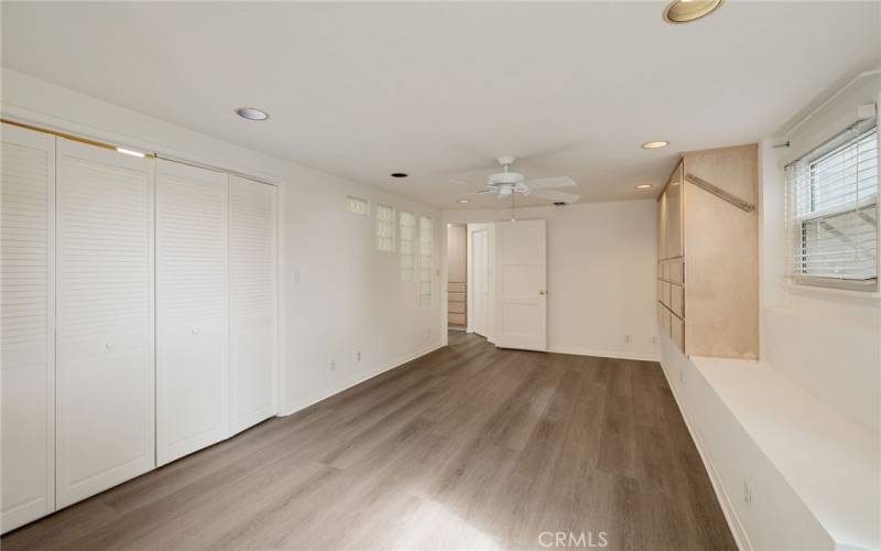 primary bedroom with enclosed laundry on the left