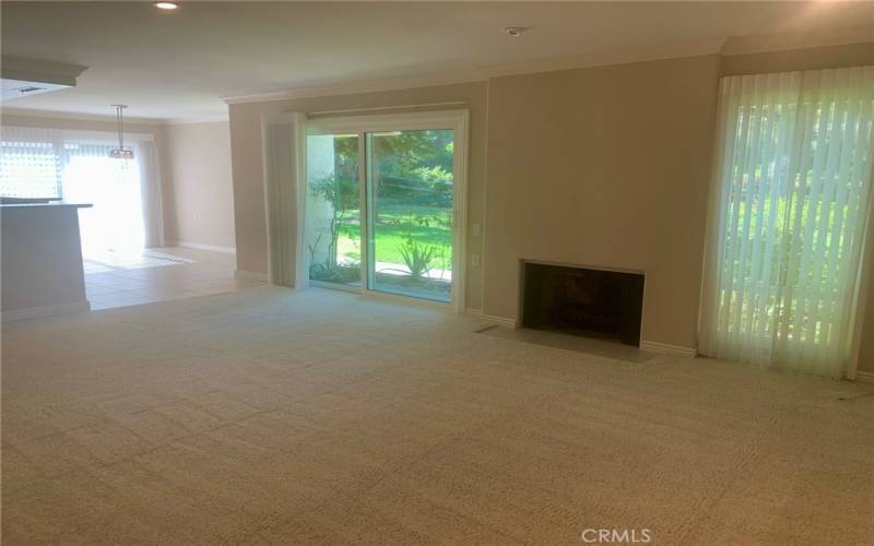 Another view of the living room looking towards the dining area at left. Note the wood-burning fireplace in the living room.