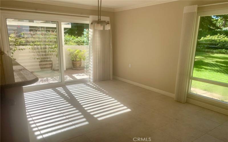 Close-up of dining area with its separate entrance to the side patio. Breakfast bar can be partially seen at far left.