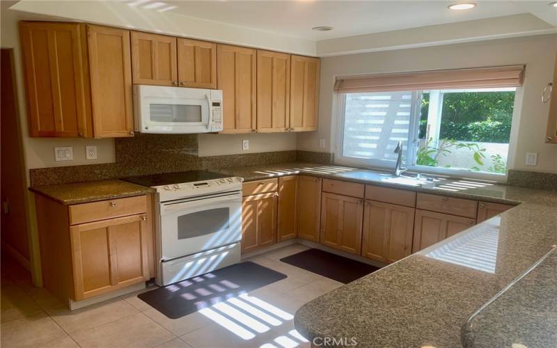 Another view of the upgraded kitchen. Note the large kitchen window that looks onto the side patio.