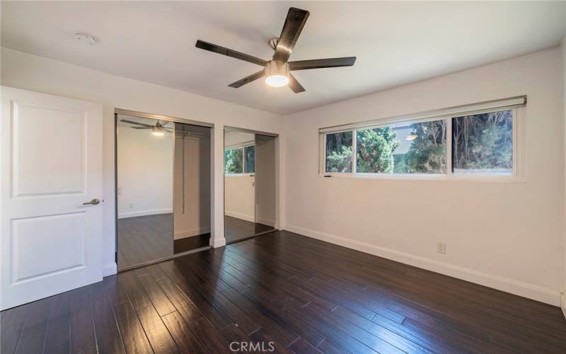 Bedroom with natural light and ceiling fan.