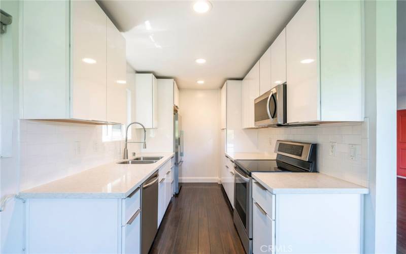 Kitchen with microwave, dishwasher and refrigerator.