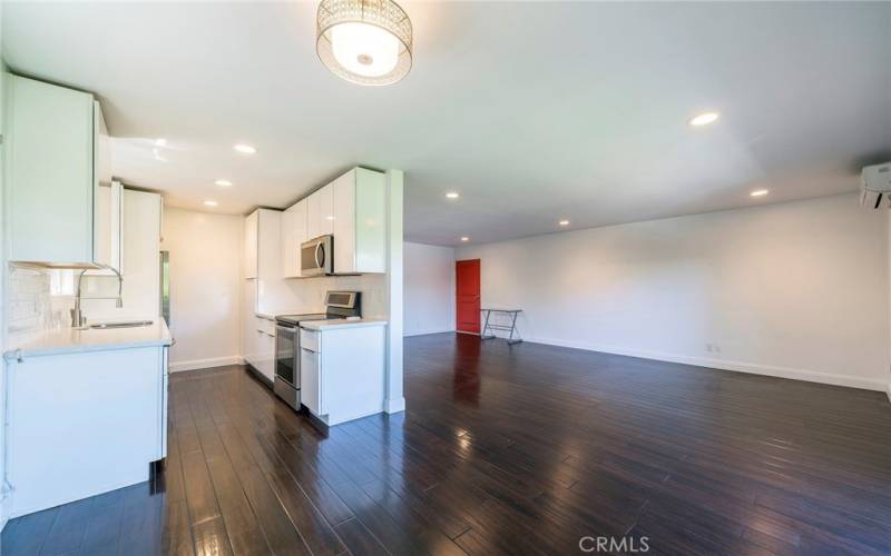 Dining area to kitchen and front door.