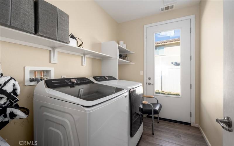 Laundry room with sink and door to side yard