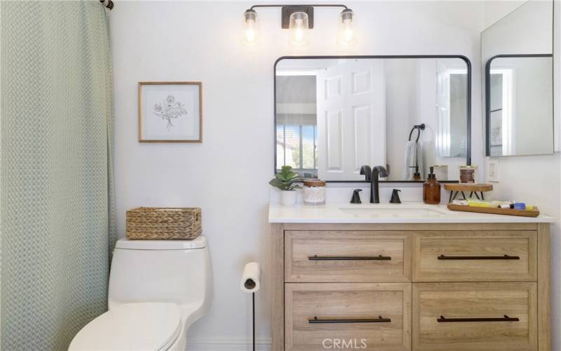 Ensuite guest bathroom has been completely remodeled with a new vanity, new lighting and plumbing fixtures as well as a new toilet