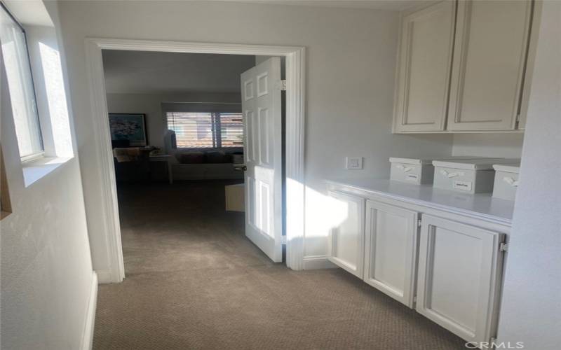 Upstairs hallway with additional cabinets and storage