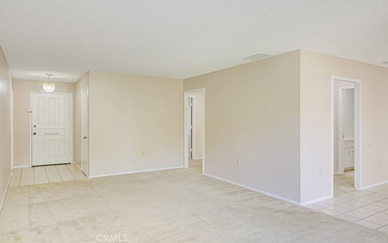 Another view of the living room looking back towards the front door (at left). Service door to the garage is just to the left of the front door.